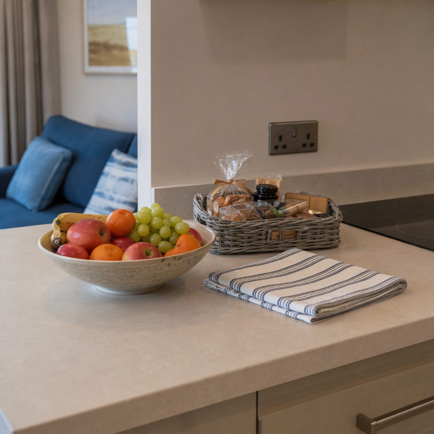 A holiday flat kitchen counter with a welcome basket