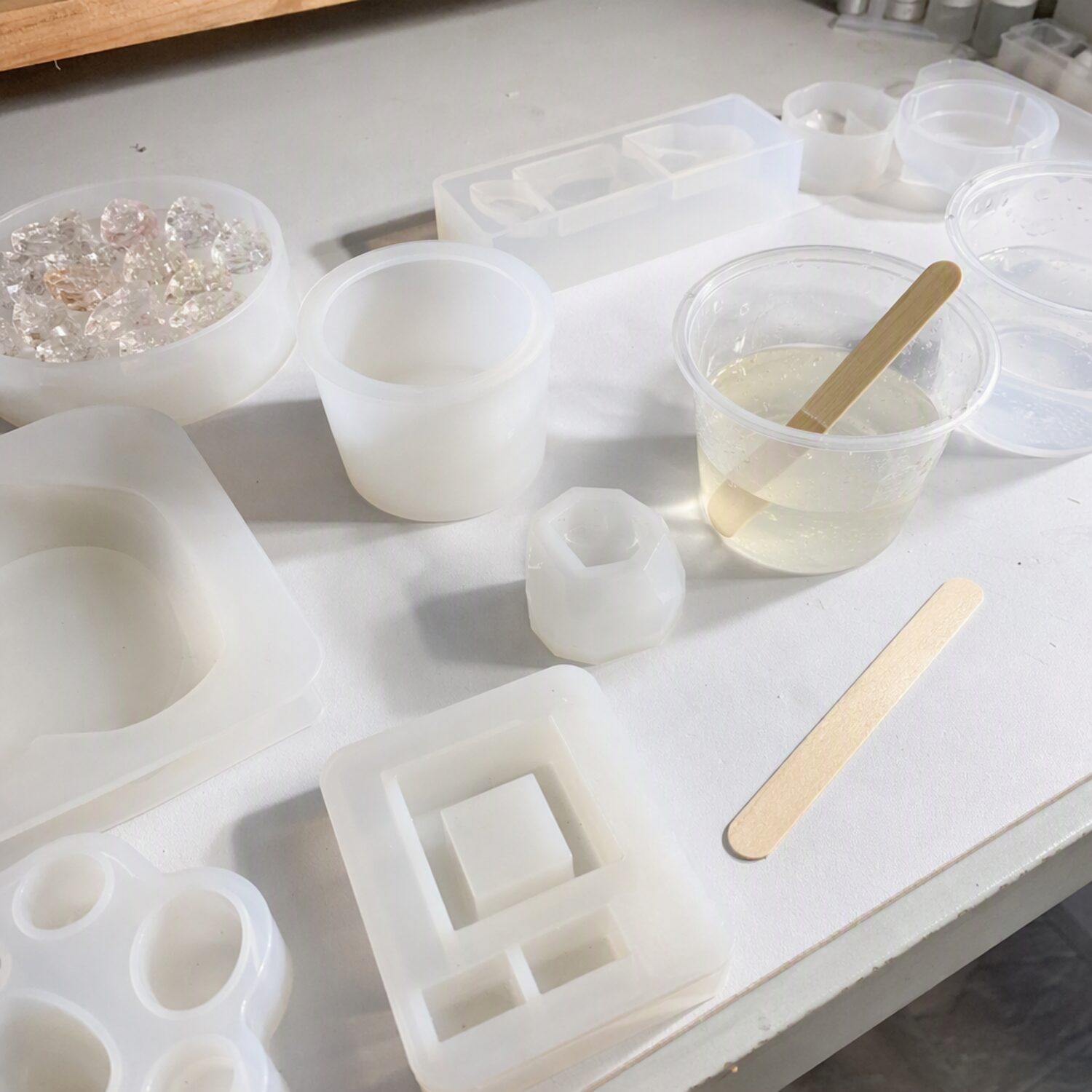 Silicone moulds and mixing cups on a craft table