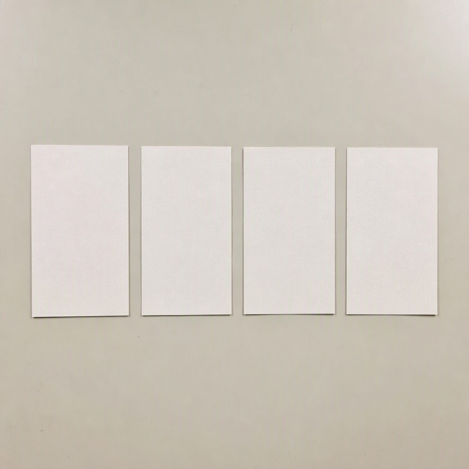 Four paper cards in a row
