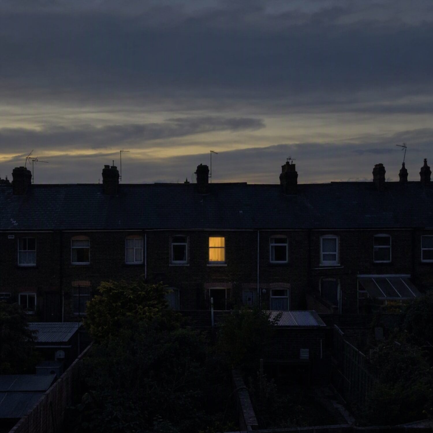 One lit window in a dark terrace
