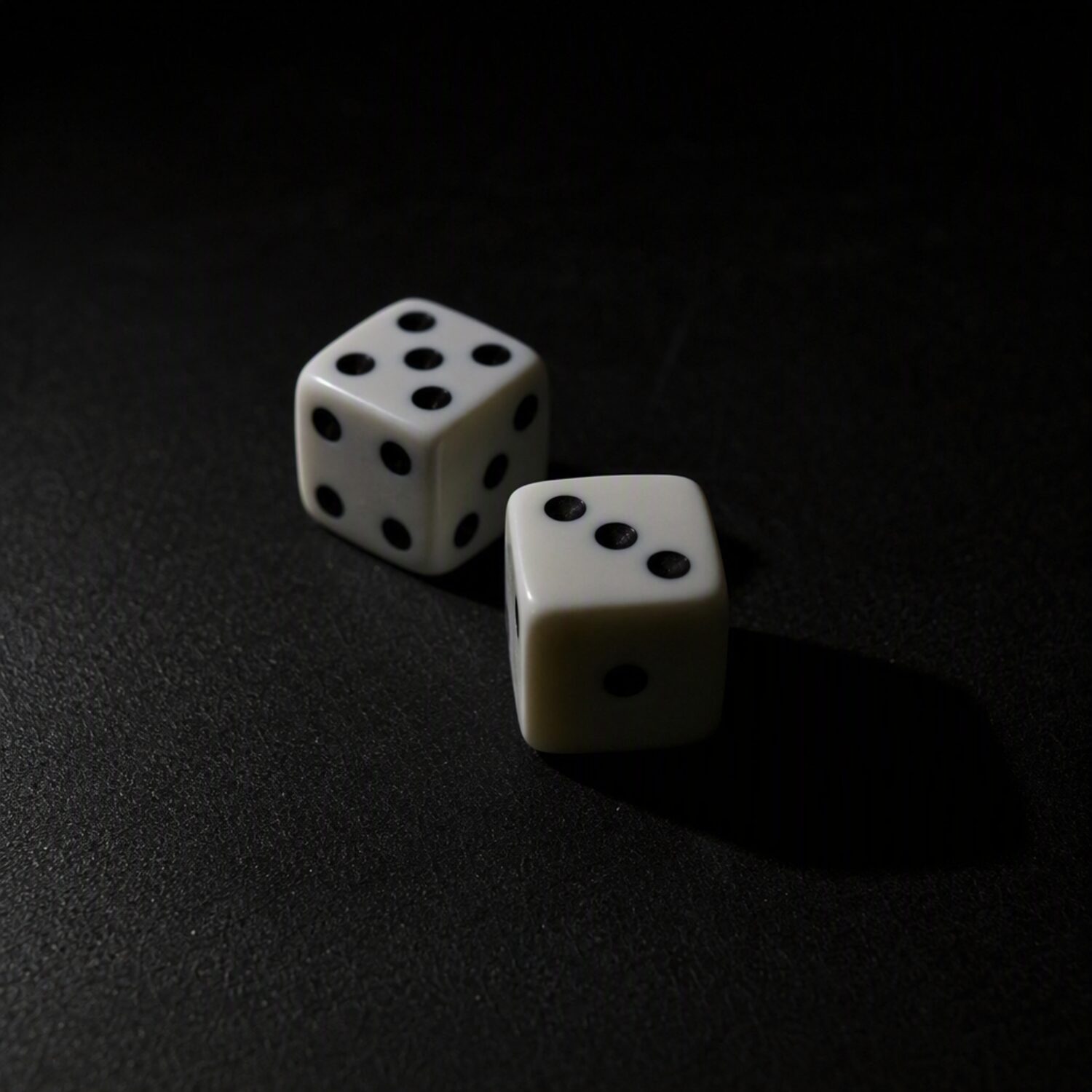 Two dice on a dark table