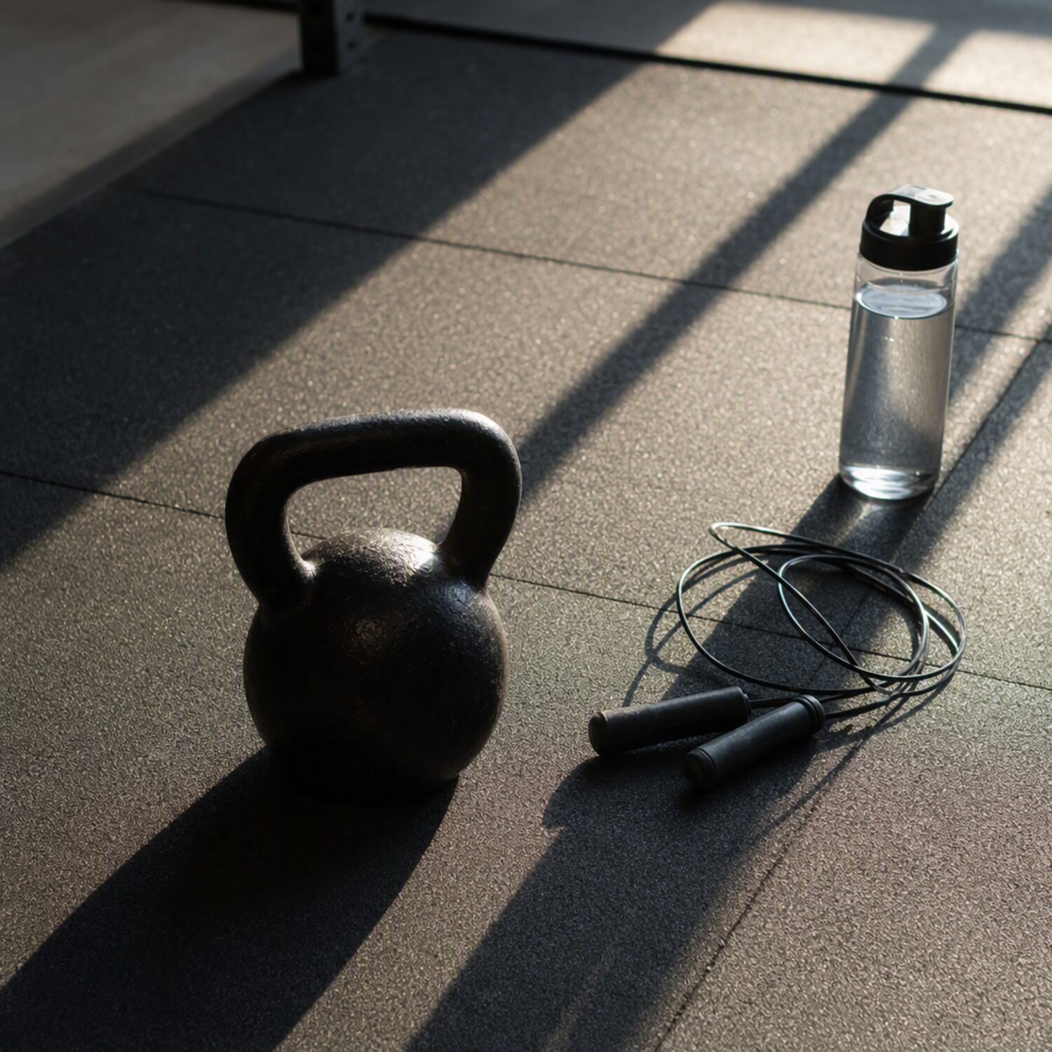 A kettlebell and jump rope on a gym floor