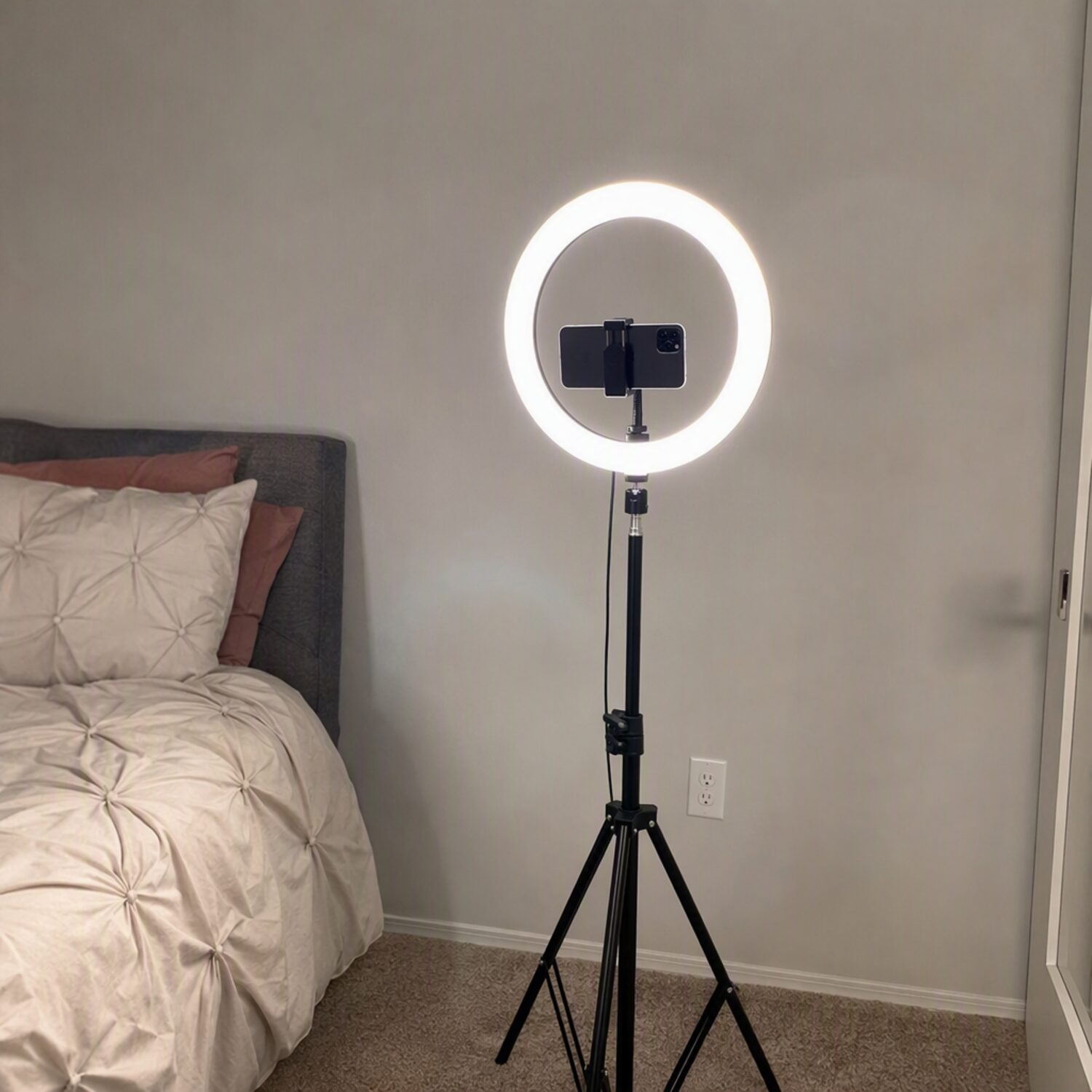 A phone on a tripod with a ring light