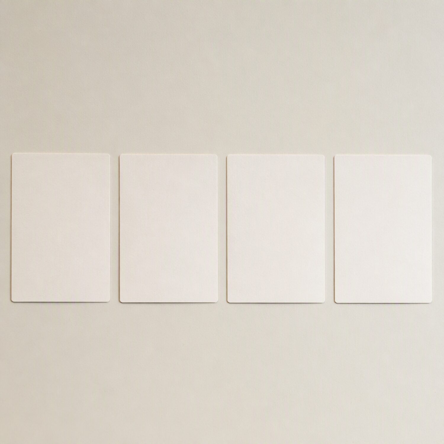 Four paper cards in a row