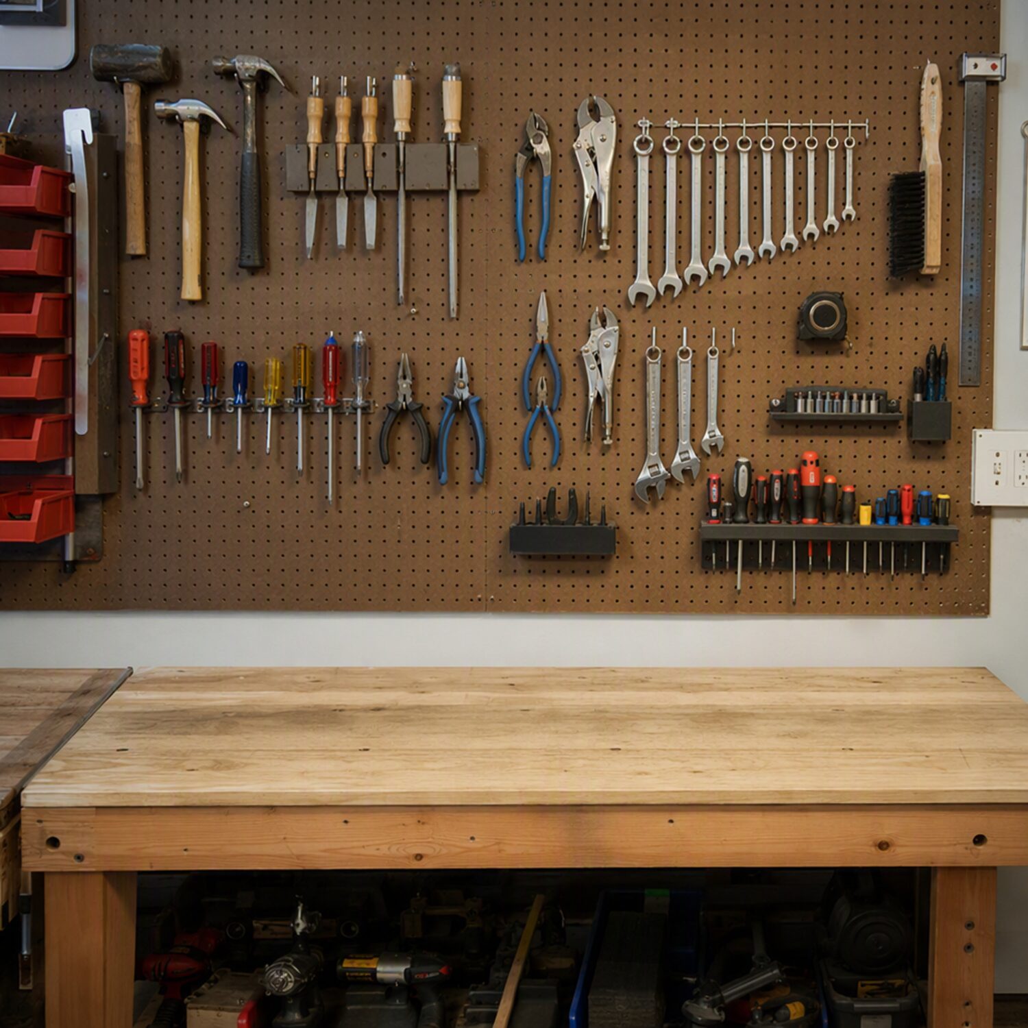 A workbench with tools on a pegboard