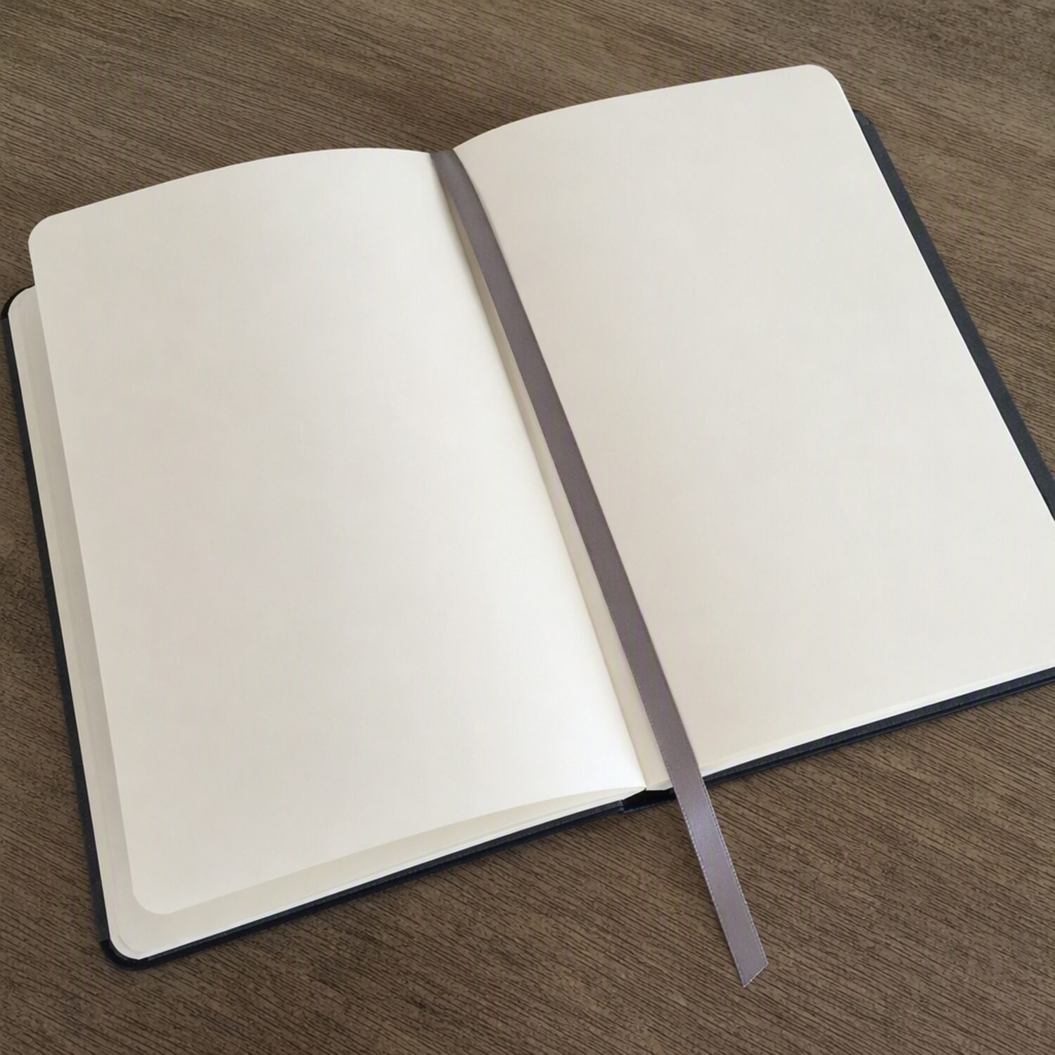 A ribbon bookmark across a blank notebook