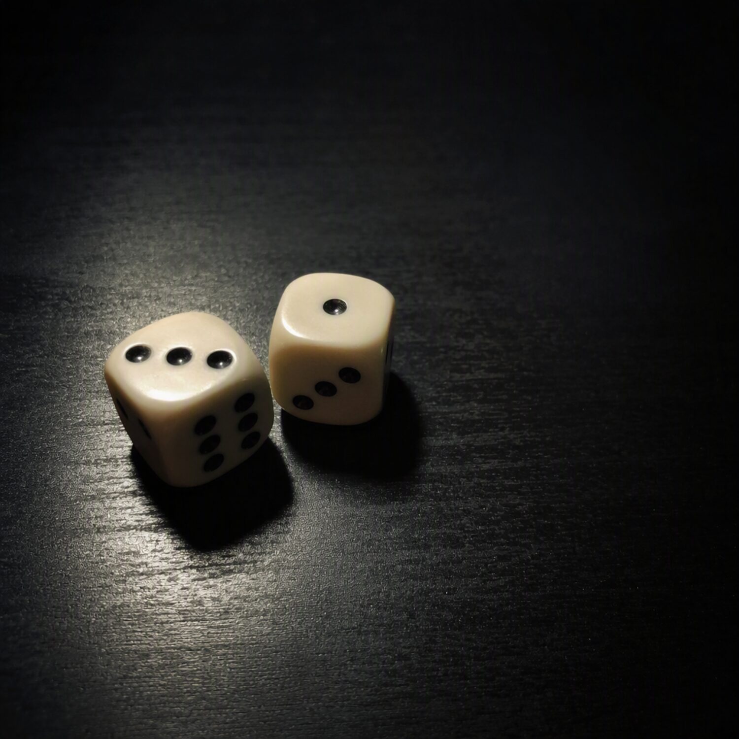 Two dice on a dark table