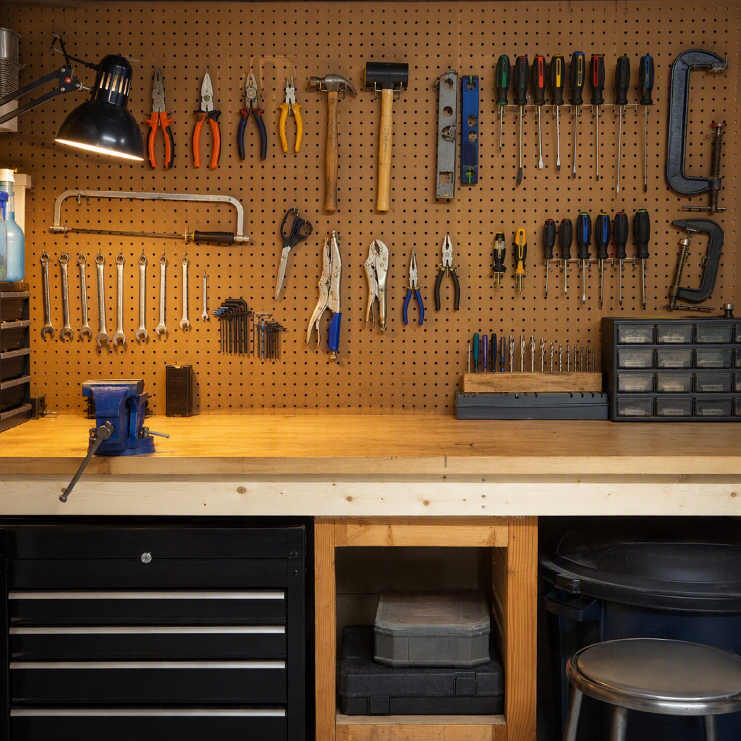 A workshop bench with tools on a pegboard