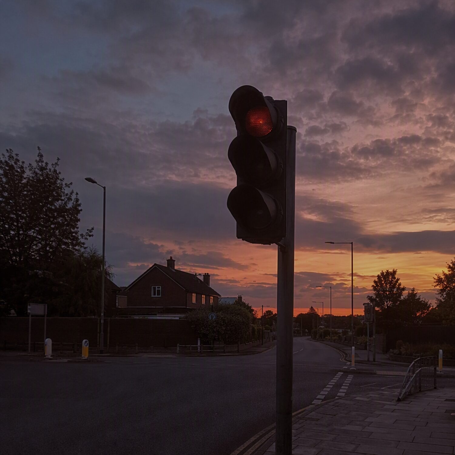 A dimmed traffic light at dusk
