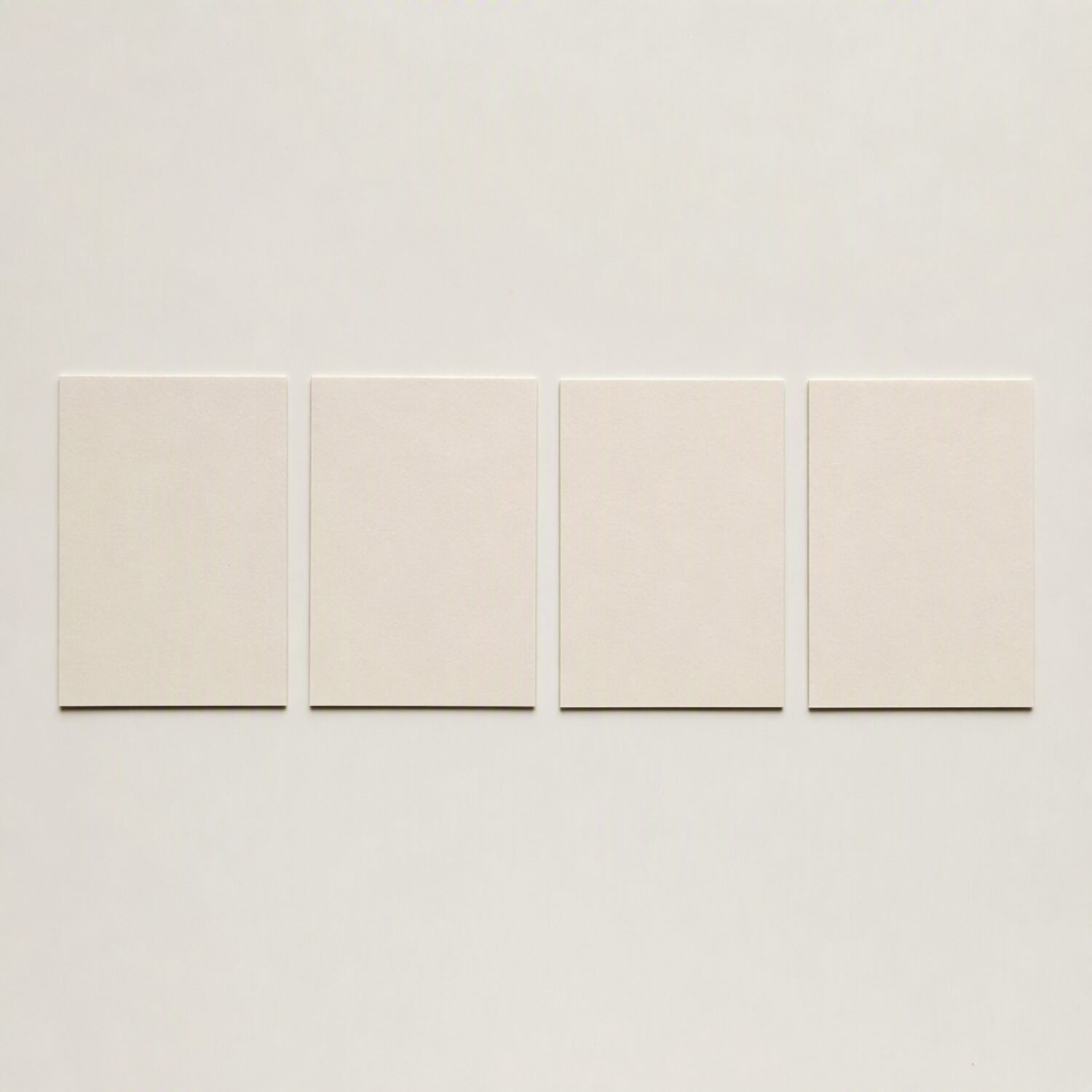Four paper cards arranged in a row