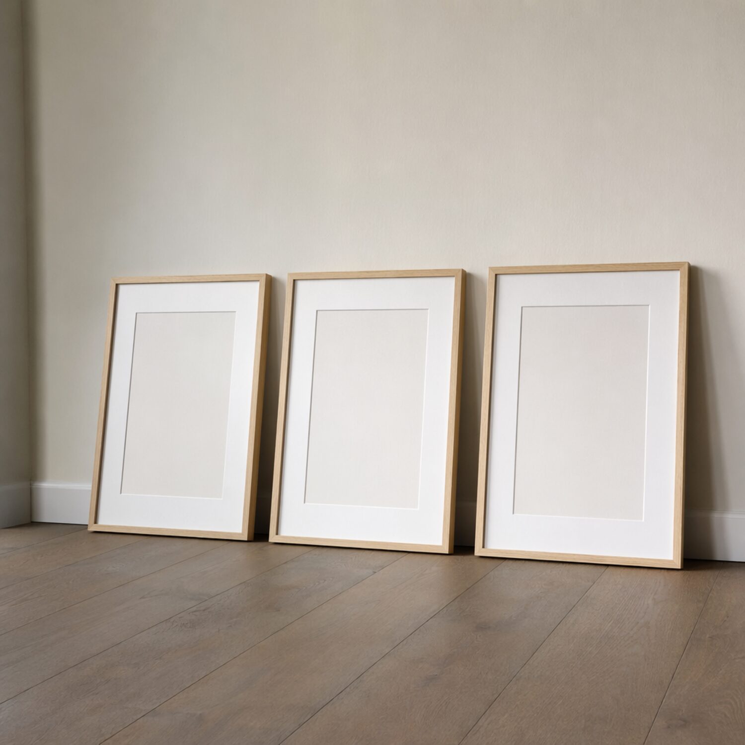 Three picture frames leaning on a wall