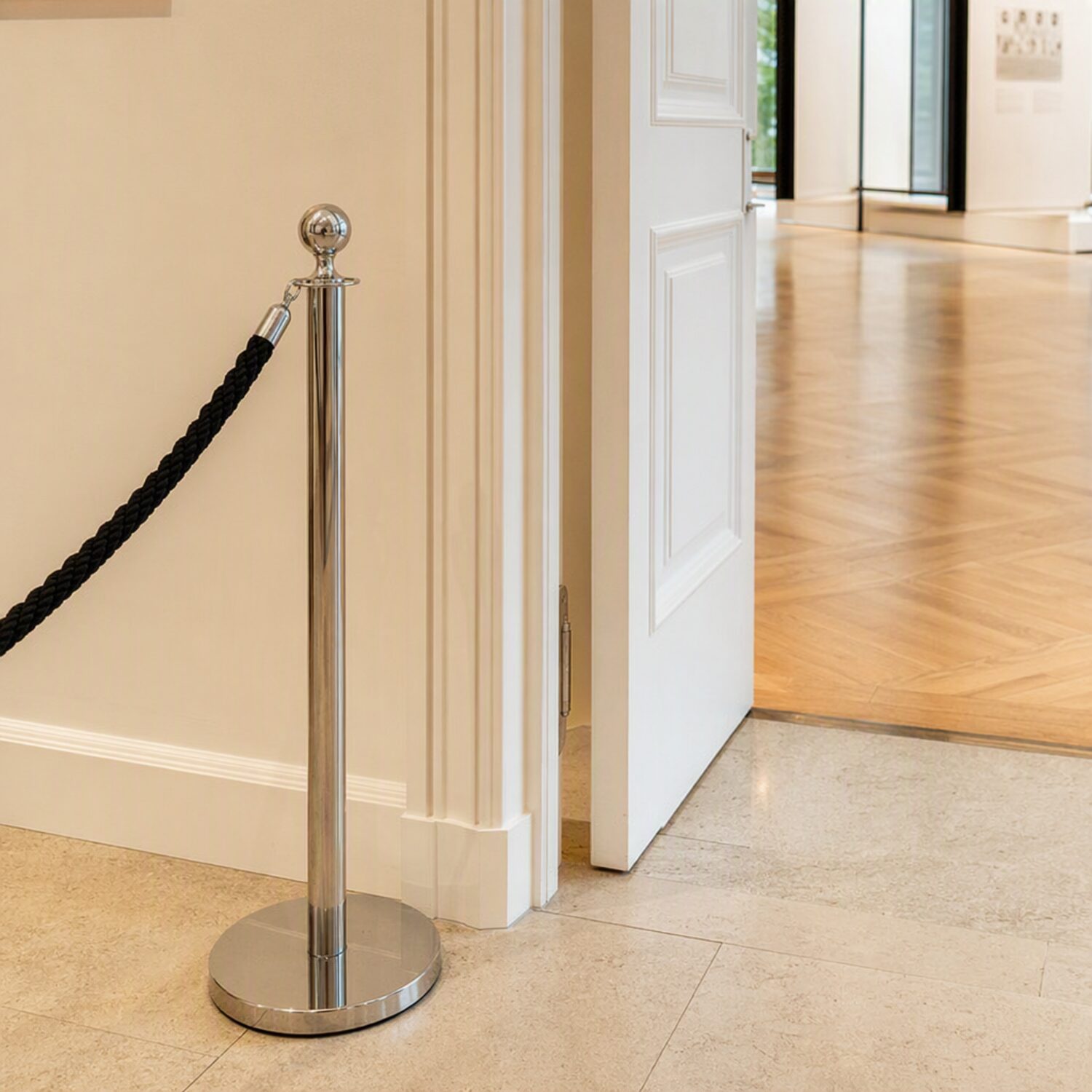 A rope barrier post beside an open doorway