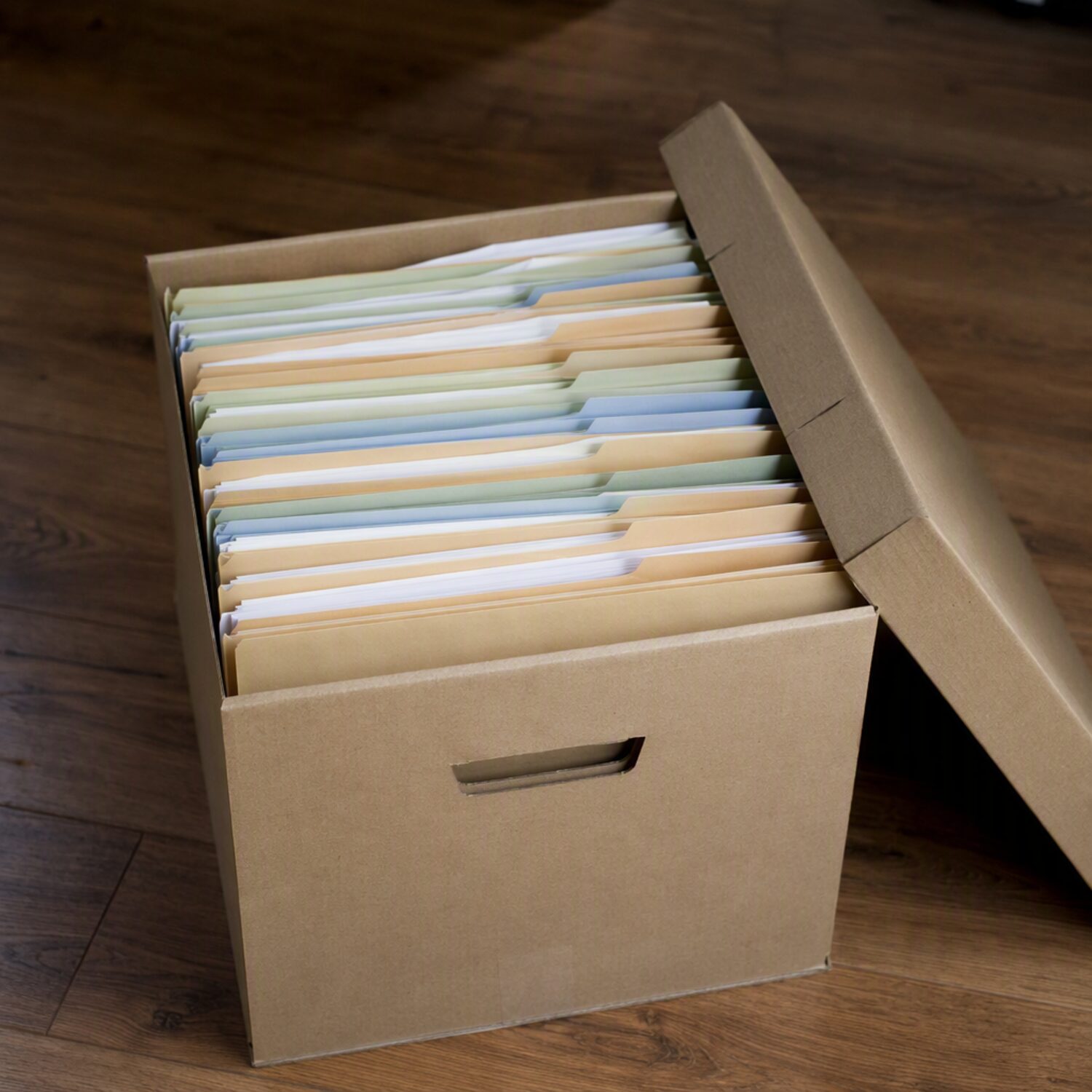 An open file box of paper folders