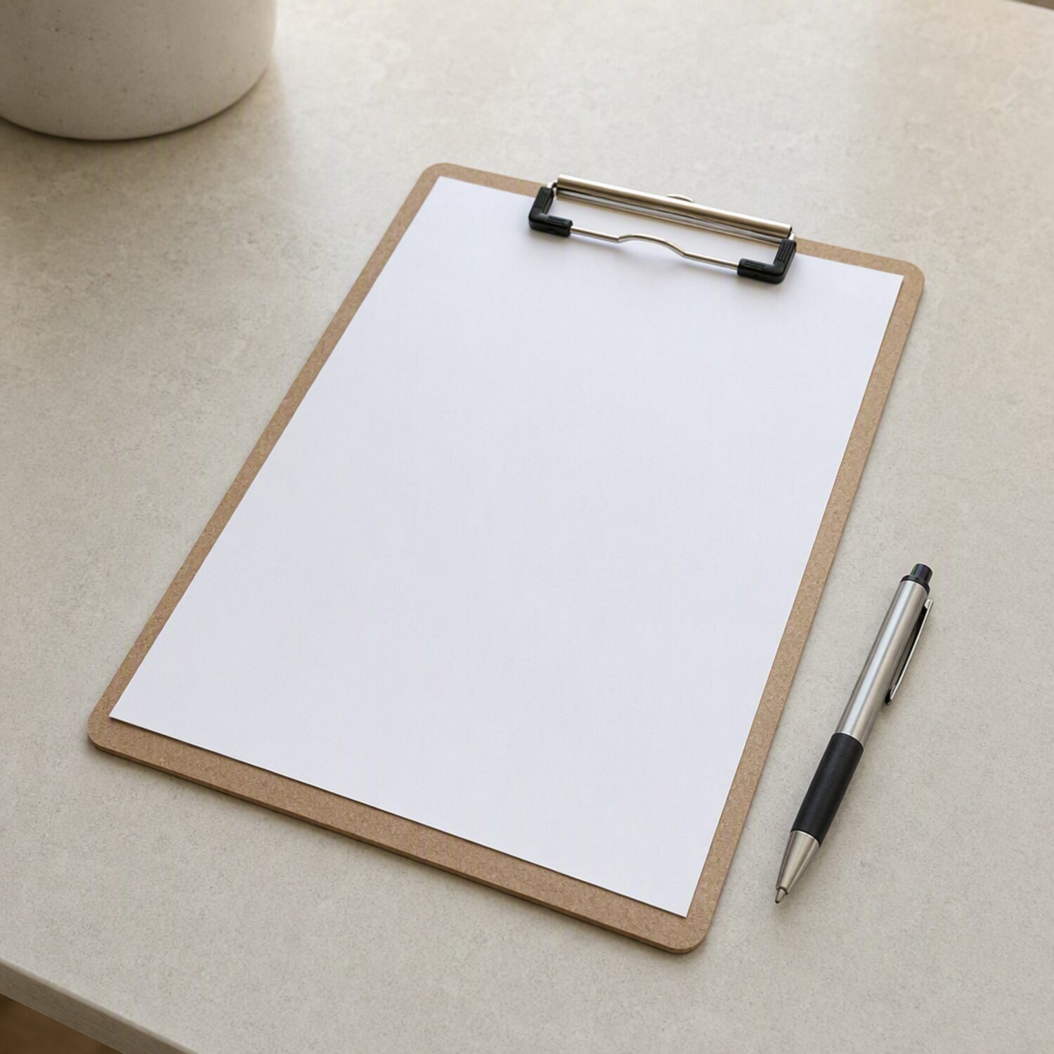 A clipboard with a blank form and a pen