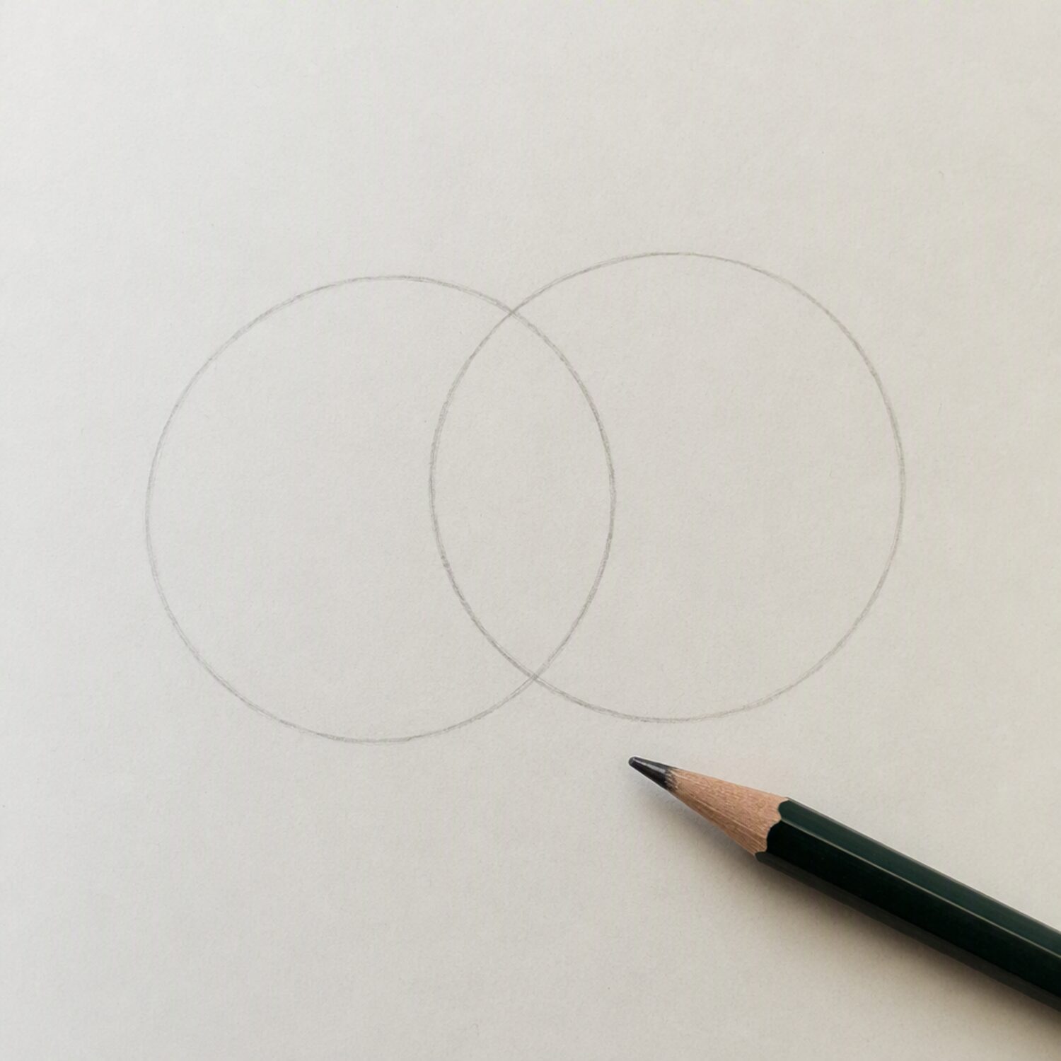 Two overlapping circles drawn on paper