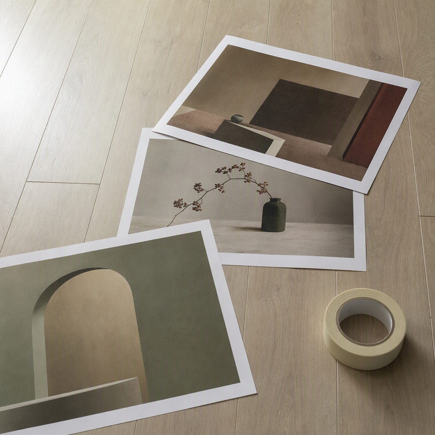 Printed art sheets overlapping on a wooden floor