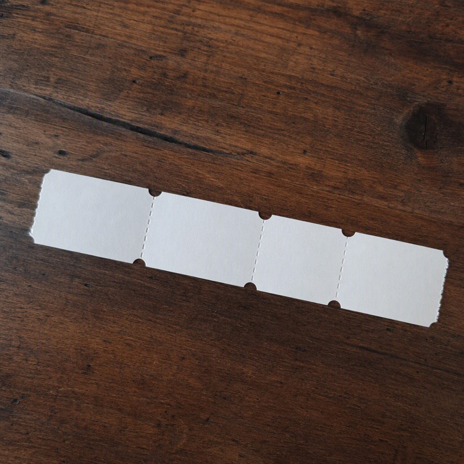 A strip of blank paper tickets on a table
