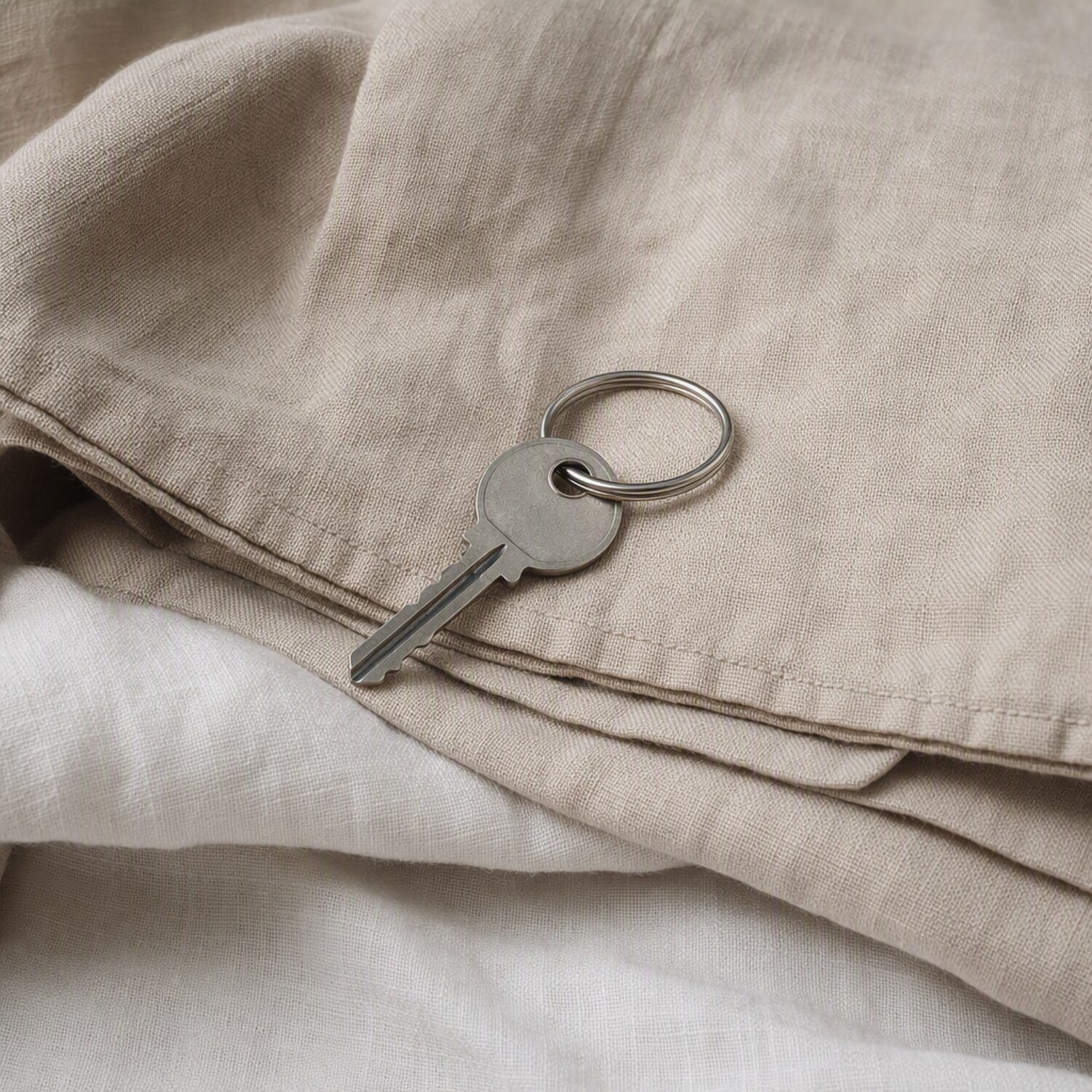 A single key on folded linen