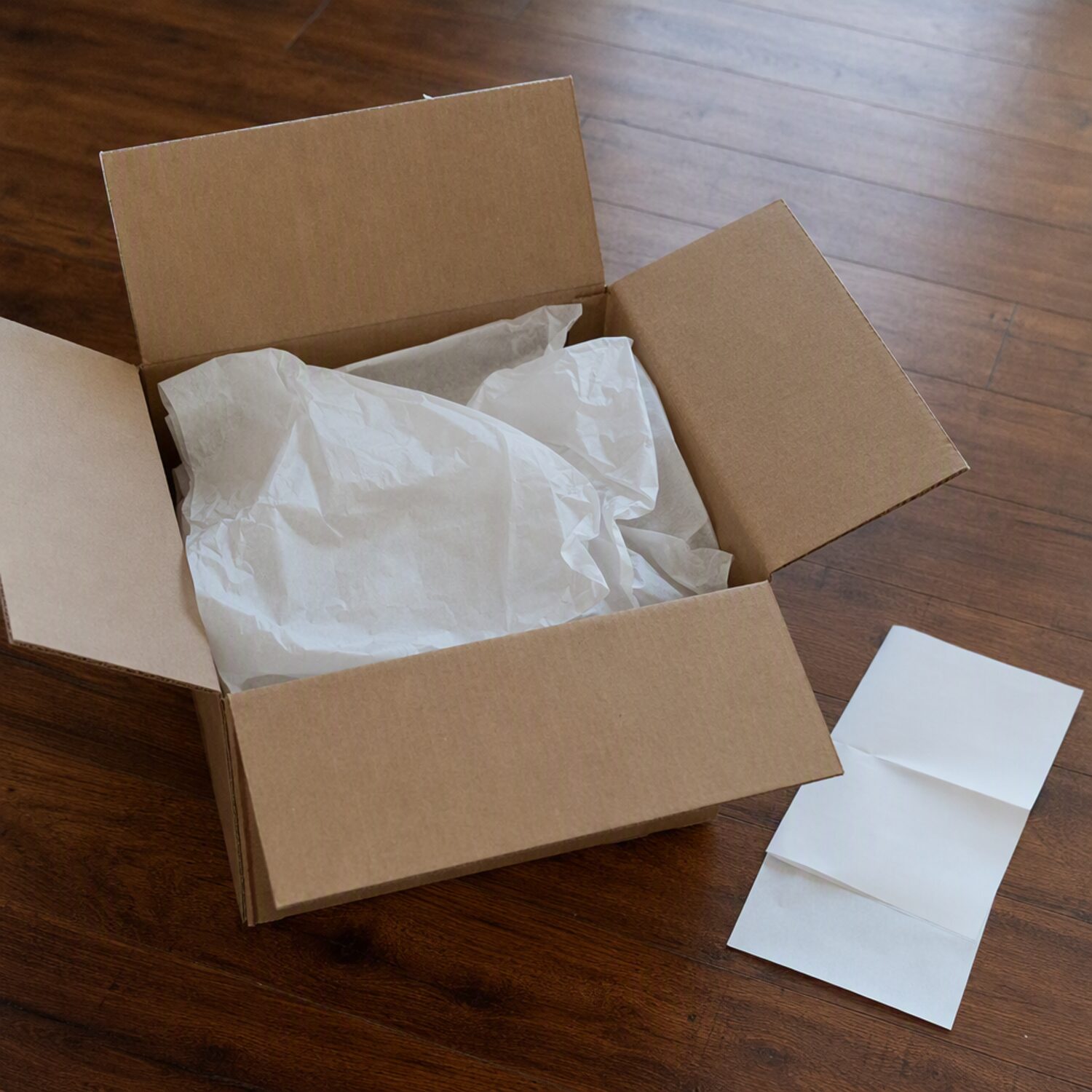 An open cardboard box with tissue paper